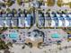 Breathtaking aerial view of beachside community with pools, palm trees, and ocean access at 129 Grand Pavilion Blvd, Isle of Palms, SC 29451