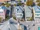 Aerial view of well-maintained homes and amenities including a pool, beach access, and a lush landscape at 129 Grand Pavilion Blvd, Isle of Palms, SC 29451