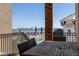 Balcony with a peek-a-boo ocean view featuring a wooden table and comfortable seating, perfect for enjoying the outdoors at 129 Grand Pavilion Blvd, Isle of Palms, SC 29451