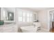 Spacious bathroom featuring a freestanding tub, dual sinks, ample lighting, and white cabinets with marble countertops at 129 Grand Pavilion Blvd, Isle of Palms, SC 29451