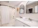 Bright bathroom featuring double sinks, granite countertops, and a tub-shower combo, a serene space for relaxation at 129 Grand Pavilion Blvd, Isle of Palms, SC 29451