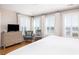 Airy bedroom with hardwood floors, a king bed, a soft rug, TV, and plenty of natural light from windows at 129 Grand Pavilion Blvd, Isle of Palms, SC 29451