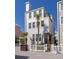 Charming three-story beach house with white siding, balcony and inviting front entrance at 129 Grand Pavilion Blvd, Isle of Palms, SC 29451