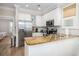 Well-lit kitchen with stainless steel appliances, white cabinets, and a breakfast bar that seats two at 129 Grand Pavilion Blvd, Isle of Palms, SC 29451