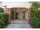 Enclosed carport area with brick accents surrounded by beautiful bushes and landscaping at 129 Grand Pavilion Blvd, Isle of Palms, SC 29451