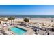 Aerial view of a pool and surrounding lounge area with beach and ocean in the background at 129 Grand Pavilion Blvd, Isle of Palms, SC 29451