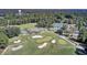 Aerial view featuring a lush golf course, community pool, and picturesque homes at 138 Back Tee Cir, Summerville, SC 29485