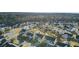 Community aerial view showcasing neatly arranged homes, mature trees, and a pond enhancing the neighborhood's appeal at 138 Back Tee Cir, Summerville, SC 29485