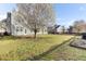 Spacious backyard featuring a lush lawn, flowering tree, and a fenced yard providing ample outdoor space at 138 Back Tee Cir, Summerville, SC 29485