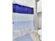 A view of a full bathroom with striped curtain and tile floor at 138 Back Tee Cir, Summerville, SC 29485