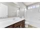 Bright bathroom showcasing a white vanity top, dark wood cabinets, and a shower-tub combo at 138 Back Tee Cir, Summerville, SC 29485