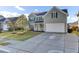 Charming two-story home featuring a well-manicured lawn, landscaping, and a two-car garage at 138 Back Tee Cir, Summerville, SC 29485