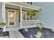 Inviting front porch with lush landscaping and a decorative white railing at 138 Back Tee Cir, Summerville, SC 29485