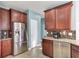 A view of the kitchen features stainless steel appliances, wood cabinets, and a stone backsplash at 138 Back Tee Cir, Summerville, SC 29485