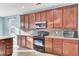 Modern kitchen features wooden cabinets, stainless steel appliances, and decorative tile backsplash at 138 Back Tee Cir, Summerville, SC 29485