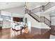 Spacious living room with soaring ceilings, hardwood floors, and staircase with iron railings at 138 Back Tee Cir, Summerville, SC 29485