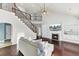 Bright and open living room with soaring ceilings and elegant staircase with iron railings at 138 Back Tee Cir, Summerville, SC 29485