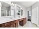 Bright bathroom featuring double sinks, cabinets, a large mirror and doorway views to the water closet at 138 Back Tee Cir, Summerville, SC 29485