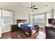 Spacious bedroom with wooden floors, ceiling fan, and plenty of natural light from the windows at 138 Back Tee Cir, Summerville, SC 29485