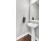 Clean powder room with a white pedestal sink, mirror, and towel rack at 138 Back Tee Cir, Summerville, SC 29485