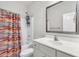Well-lit bathroom featuring a combination shower and tub, a mirrored medicine cabinet, and a white vanity at 139 Ancestry Ln, Moncks Corner, SC 29461