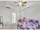 View of a bedroom with neutral walls, carpet, tray ceiling and ceiling fan, and shuttered windows at 139 Ancestry Ln, Moncks Corner, SC 29461