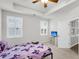 Neutral bedroom featuring carpet floors, a tray ceiling with fan, and bright, shuttered windows at 139 Ancestry Ln, Moncks Corner, SC 29461