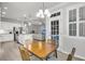 Bright dining area features an open floorplan and views of the modern white kitchen and living room at 139 Ancestry Ln, Moncks Corner, SC 29461