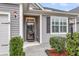 The front entrance of the home with a glass-paneled door and dark shutters at 139 Ancestry Ln, Moncks Corner, SC 29461