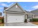 Charming home with a two-car garage, gray siding, and well-maintained landscaping at 139 Ancestry Ln, Moncks Corner, SC 29461