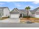 Charming single-Gathering home with a two-car garage, a manicured lawn, and a mature palm tree at 139 Ancestry Ln, Moncks Corner, SC 29461