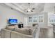 Bright living room featuring a trey ceiling, hardwood floors, and an open layout at 139 Ancestry Ln, Moncks Corner, SC 29461
