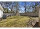 Backyard view with a wooden deck and partial fence, showcasing an air conditioning unit at 1605 Evergreen St, Charleston, SC 29407