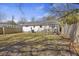 A cozy backyard with a small wooden deck, partially fenced, and featuring sparse grass and shaded areas at 1605 Evergreen St, Charleston, SC 29407