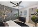 Stylish bedroom featuring bold wallpaper, a ceiling fan, and ample natural light at 1605 Evergreen St, Charleston, SC 29407