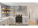Bright kitchen with stainless steel appliances, herringbone backsplash, and hardwood flooring at 1605 Evergreen St, Charleston, SC 29407