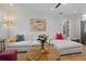 Bright living room with white shiplap walls, and cozy seating; perfect for relaxing and entertaining at 1605 Evergreen St, Charleston, SC 29407