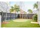 Backyard putting green with a dark wood fence providing privacy at 1625 Oak Leaf St, Daniel Island, SC 29492