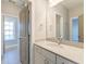 Bright bathroom with white vanity, stone countertop, mirror, and ample cabinet space at 1625 Oak Leaf St, Daniel Island, SC 29492
