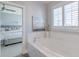 Bright bathroom with a soaking tub and view into the bedroom at 1625 Oak Leaf St, Daniel Island, SC 29492