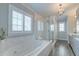 Bright bathroom featuring a soaking tub and a glass shower stall at 1625 Oak Leaf St, Daniel Island, SC 29492