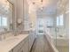 A stylish bathroom with a shower, a bathtub and chandelier lighting at 1625 Oak Leaf St, Daniel Island, SC 29492