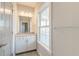 Bright bathroom featuring a white vanity, stone countertop, mirror, and plenty of natural light at 1625 Oak Leaf St, Daniel Island, SC 29492