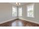 Bright bedroom featuring hardwood floors and three large windows offering ample natural light at 1625 Oak Leaf St, Daniel Island, SC 29492