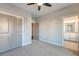 Spacious bedroom featuring a carpeted floor, gray paneled closet doors, and an ensuite bathroom at 1625 Oak Leaf St, Daniel Island, SC 29492