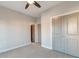 Neutral bedroom featuring a ceiling fan, carpeted floor, and closet with gray paneled doors at 1625 Oak Leaf St, Daniel Island, SC 29492