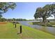 Picturesque community lake view with manicured lawn, mature trees, and rope fencing at 1625 Oak Leaf St, Daniel Island, SC 29492