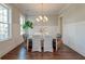 Dining room with chandelier lighting, white wood paneling, and three windows at 1625 Oak Leaf St, Daniel Island, SC 29492