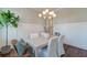 Dining room with a chandelier, white paneling, and a fiddle leaf fig tree at 1625 Oak Leaf St, Daniel Island, SC 29492