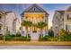 Inviting two-story home featuring double front porches, classic columns, a symmetrical facade, and tidy landscaping at 1625 Oak Leaf St, Daniel Island, SC 29492